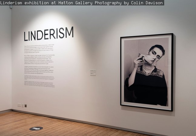 Photo of Linderism exhibition featuring a black and white photomontage and the exhibition intriduction