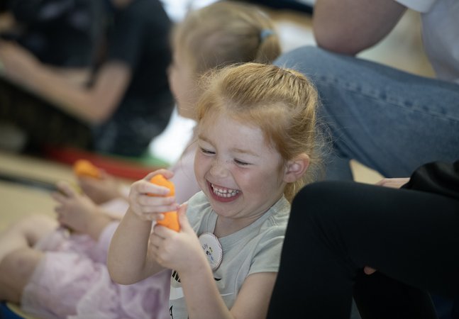 small girl smiling during activity with story 