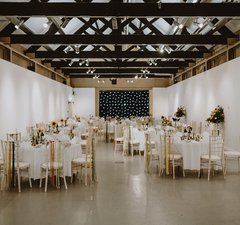 A space set up for an event with tables and chairs