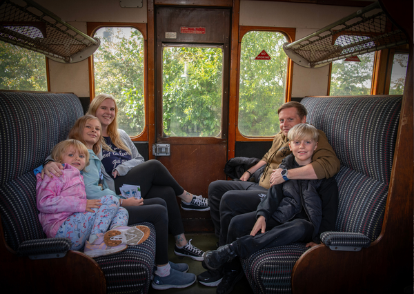 Family on board heritage train ride at Stephenson Steam Railway