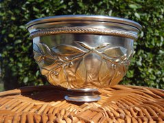 Silver cup showing detail of laurels