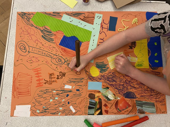 A photograph of a drawing made by a child on orange paper