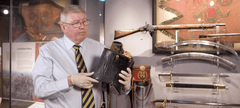 screen shot of man holding object in gallery