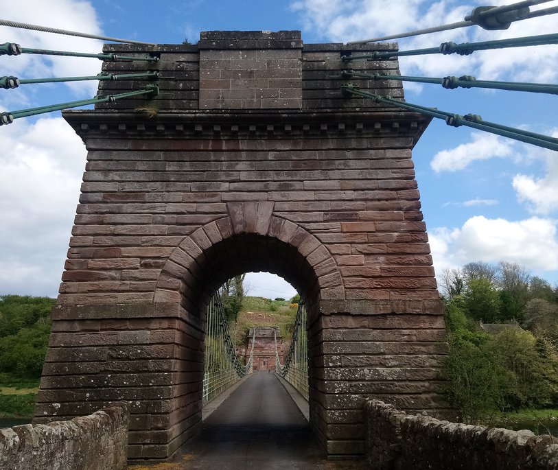 a stone structure that holds up one side of a suspension bridge