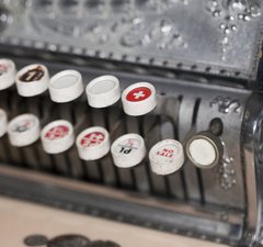 An antique cash register, with levers shown in close-up