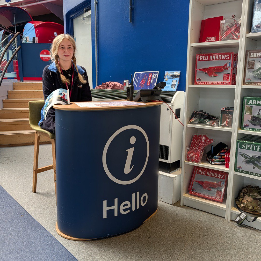 Woman at a museum welcome desk Woman at a museum welcome desk