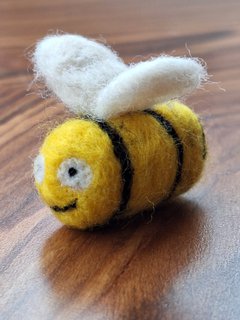 A photograph of a needle felted bee.