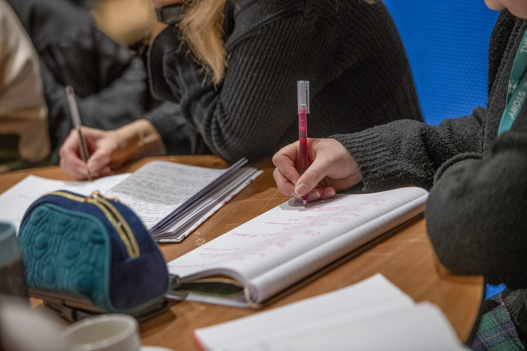 People taking notes at a training session.