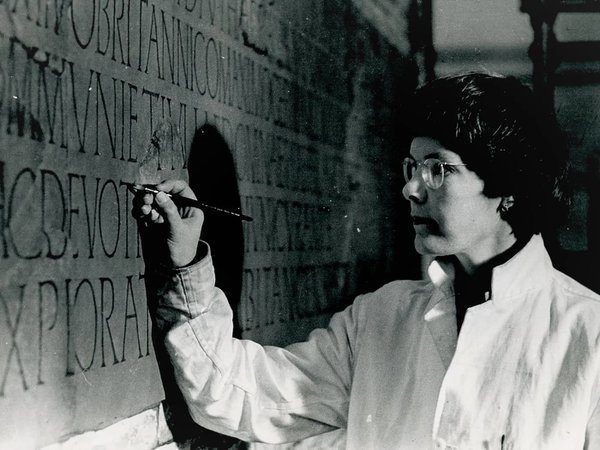Mary Hurrell painting a Roman inscription from Risingham Roman fort in the former Museum of Antiquities