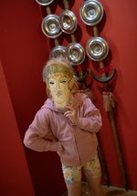 Child with mask in front of Roman standards