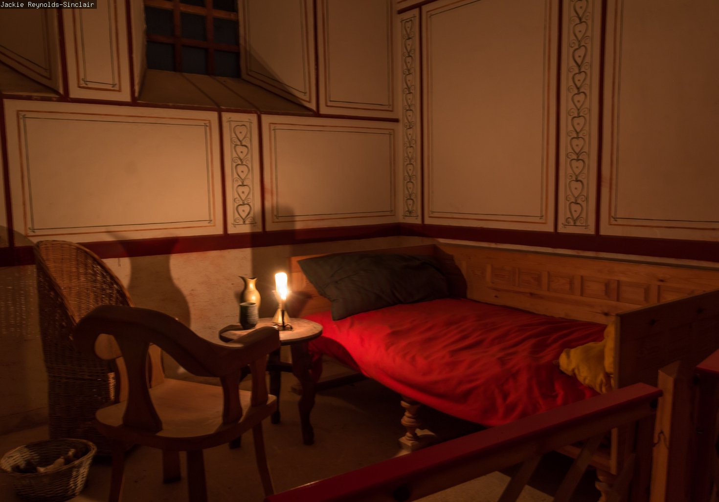 The reconstructed Commander's house lit by a candle 