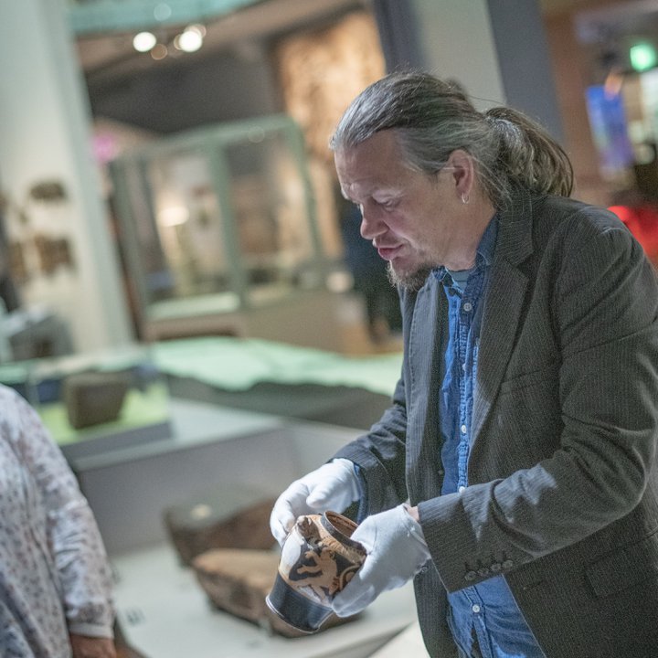 Keeper of Archaeology holding a pot