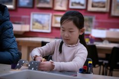 A photograph of a young girl crafting.