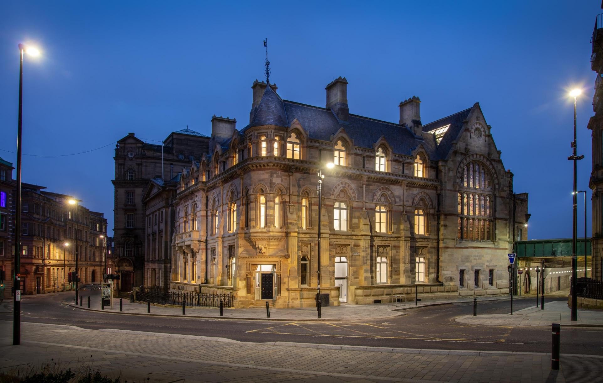 A large sandstone building with at least three floors. A large sandstone building with at least three floors.