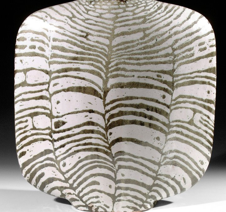 A black and white striped ceramic vessel