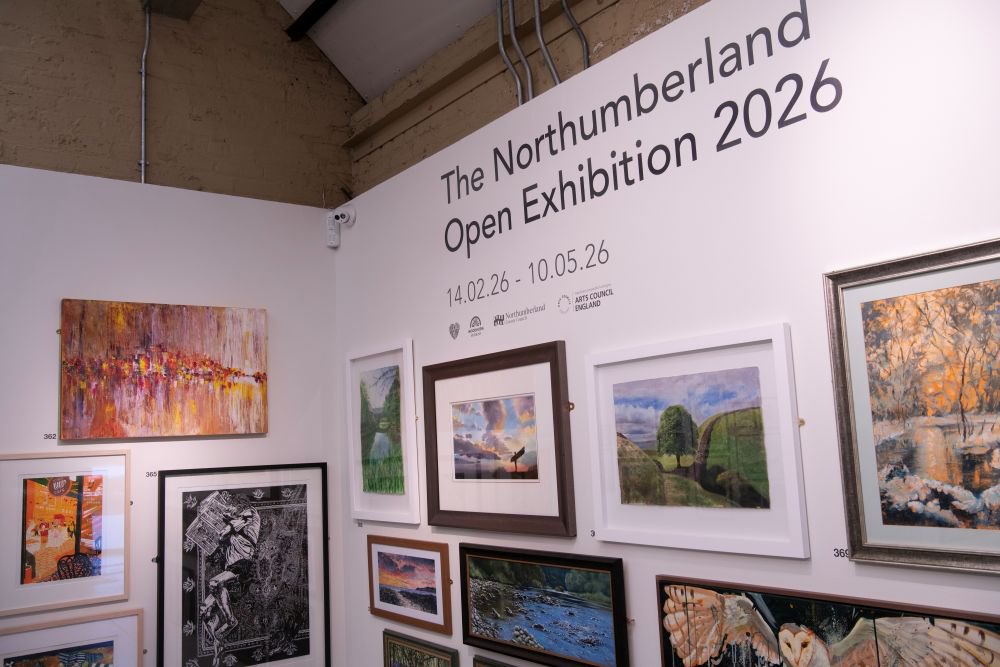 Paintings hung on a wall 'salon' style.