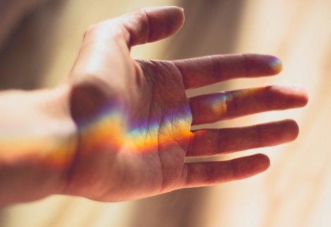 hand with rainbow light landing on the palm