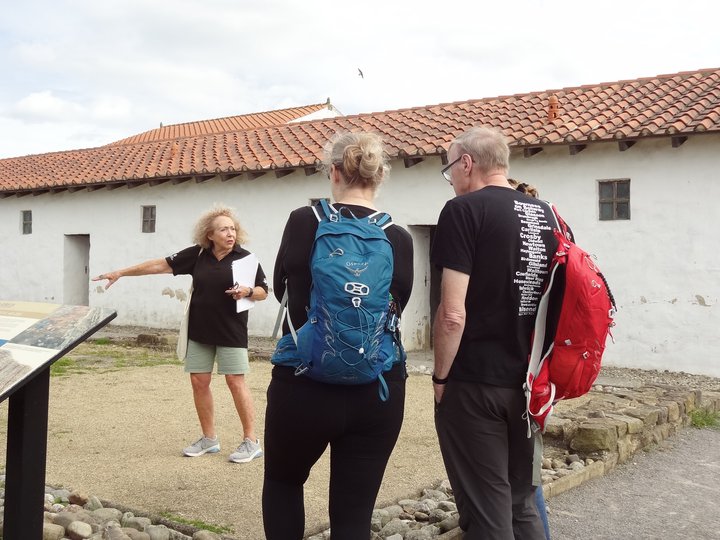 Woman giving a tour of an historic site
