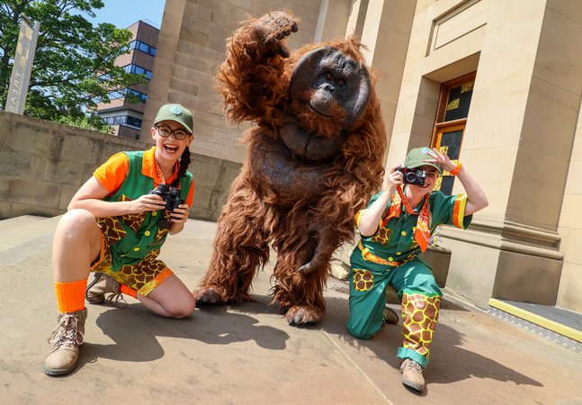 Two rangers and a Orangutan