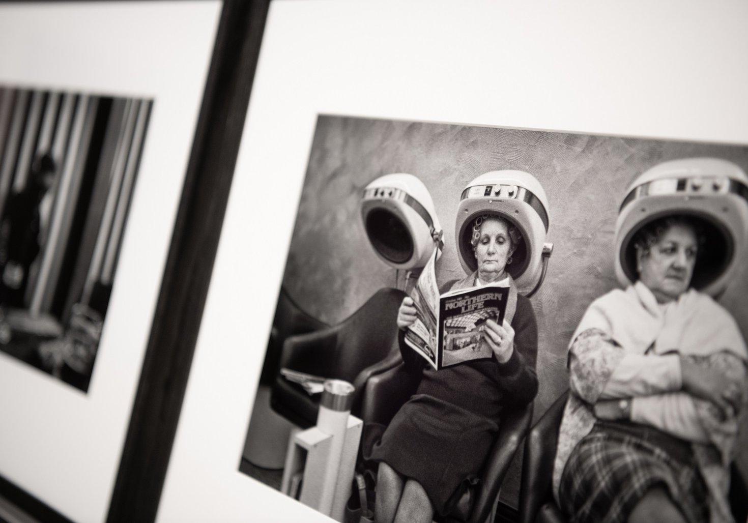 Close up of a framed black and white photograph showing older women at the hairdresser's