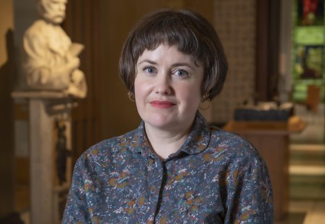 Portrait of artist Ruth Ewan standing in the marble hall of the Laing Art Gallery