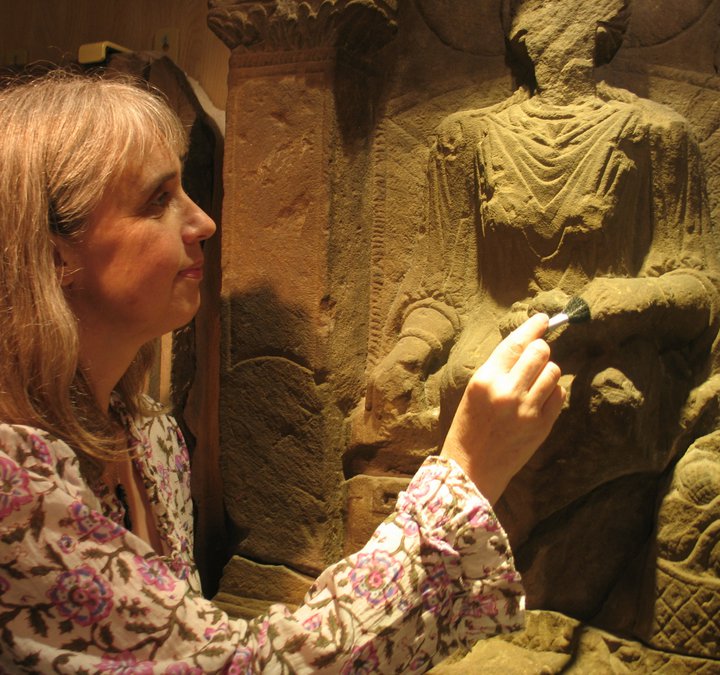 Keeper of Archaeology Alex Croom cleaning the Regina Tombstone