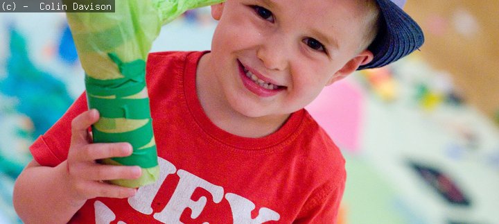 A boy holding his creation at a Big Wednesday event
