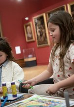 Two children taking part in a craft activity together.