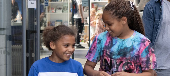 Two girls smile at each other Discovery Museum