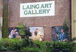 A close up of the exterior of the Laing Art Gallery. The brickwork includes three artworks