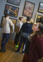 A child looks at a display of paintings in the Ashington Group Gallery at Woodhorn Museum 