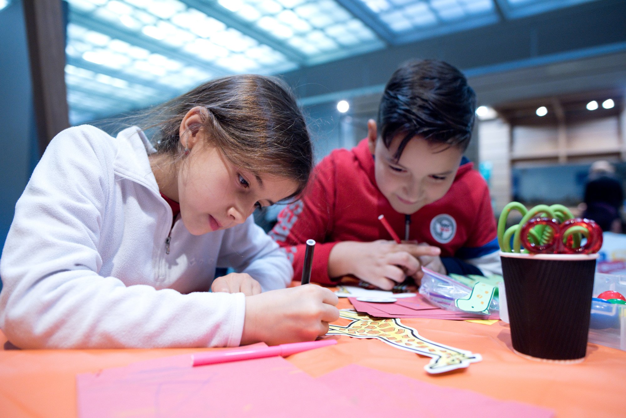 A young girl and boy take part in a craft activity at the Great North Museum, Newcastle