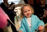 A young visitor to the Great North Museum holds a paper butterfly on a stick