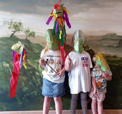 Three young children wearing handmade cavalry style masks