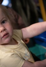 little girl plays in gallery