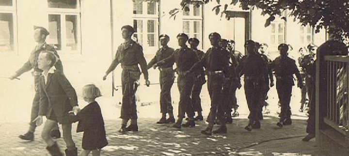 Tank crew of the 13th/18th Hussars celebrating victory with the local population, 1945
