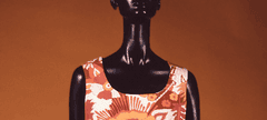 White shift dress with orange flower print display on a mannequin