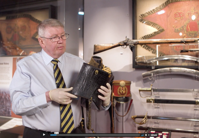 screen shot of man holding object in gallery