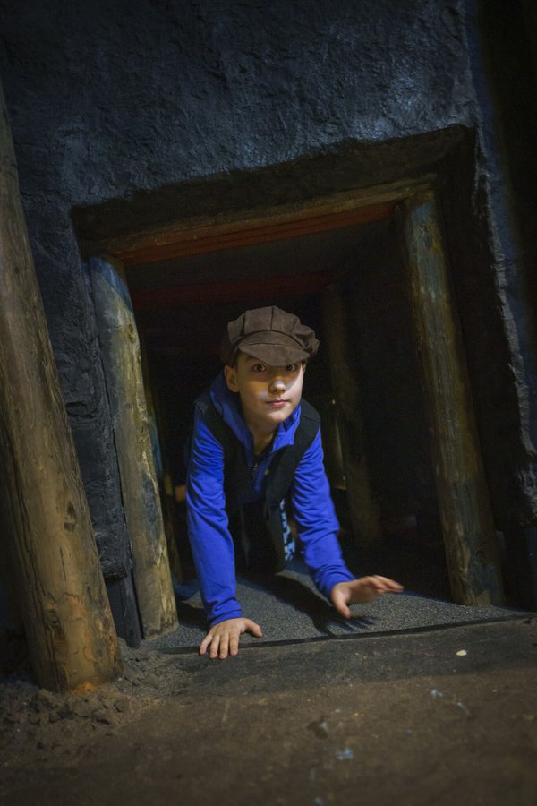 Primary school child exploring replica shaft