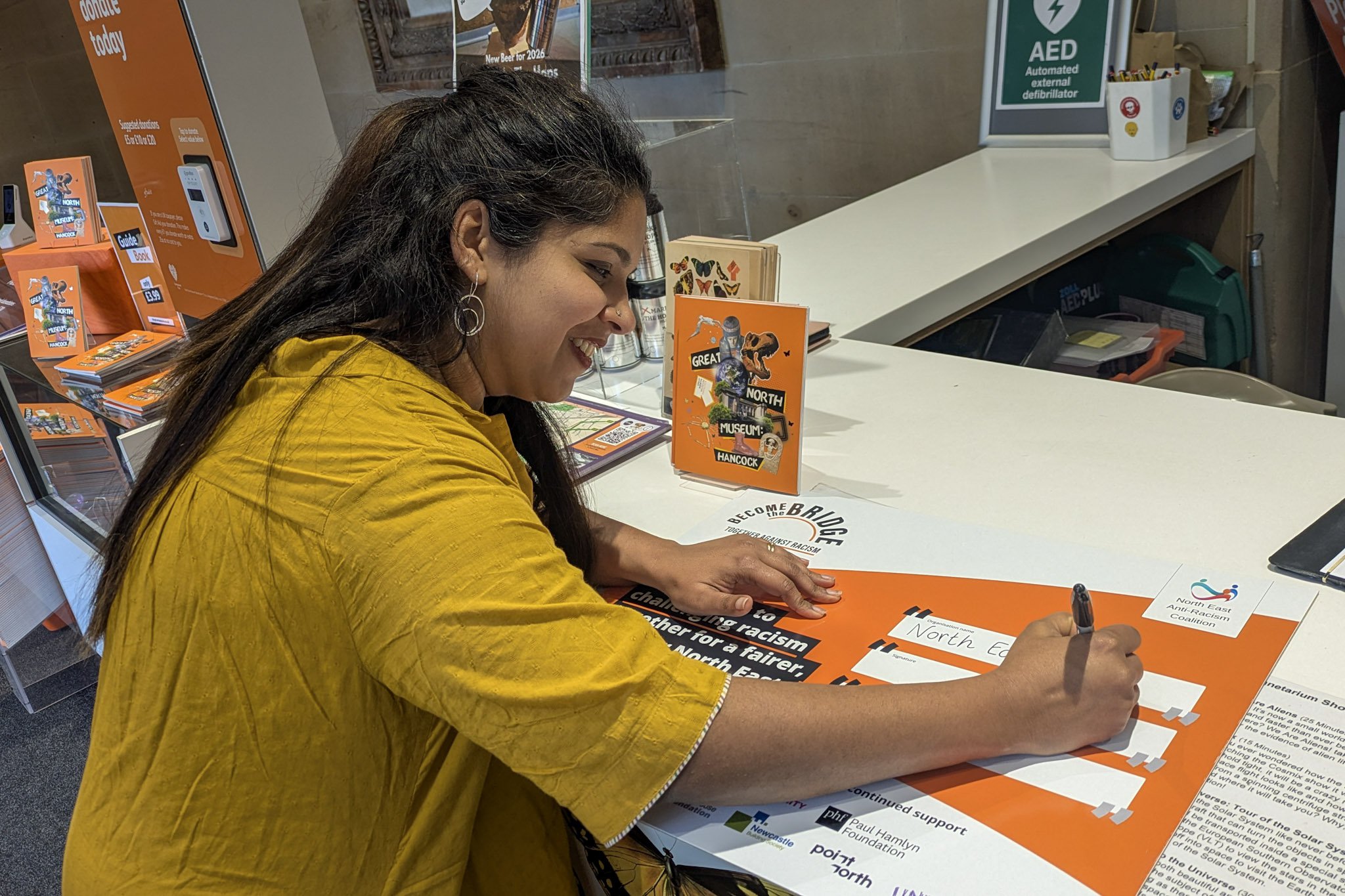Woman signing a pledge card.