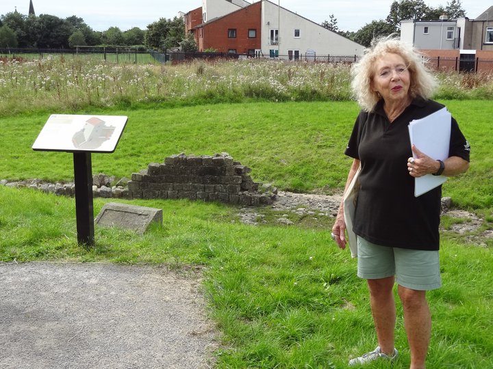 Woman standing near an information board