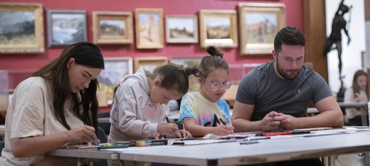 A family of four making crafts