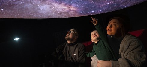 A family in a planetarium 