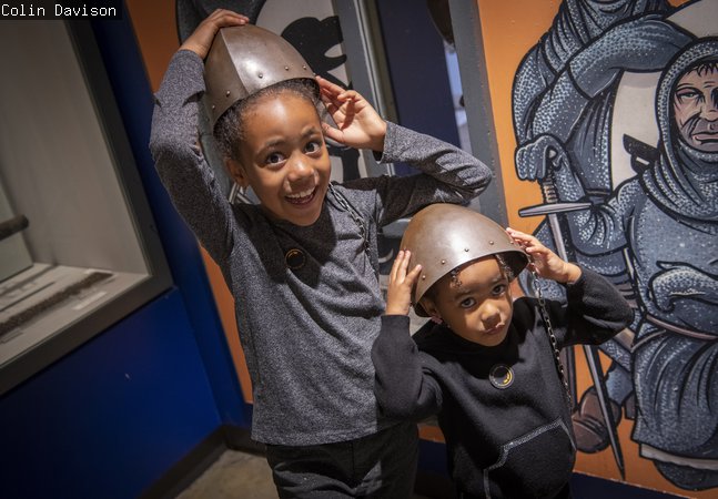 Two little girls try on armour in Newcastle Story 
