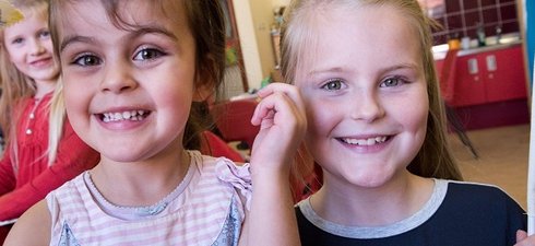 two girls aged 8 smiling 