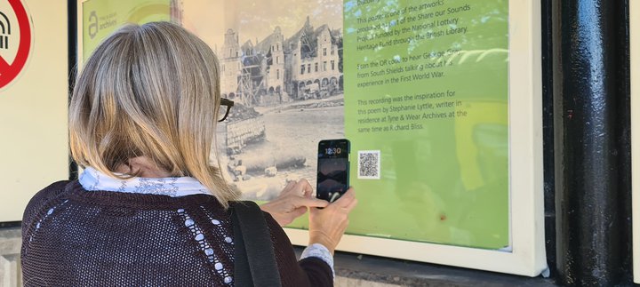 Image of Metro station poste with women looking on in interest with phone