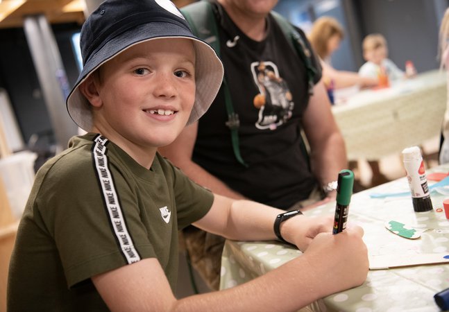 boy smiling doing crafts