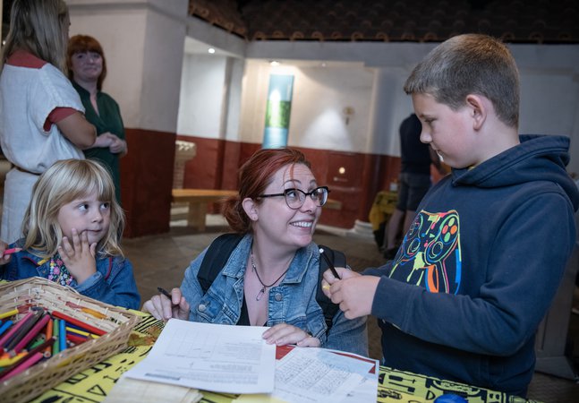 Young girl, mother, young boy doing craft activities