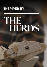A photo of a cardboard Pangolin puppet. The image includes an ‘Art Fund’ logo and an ‘Inspired by the herds’ logo.