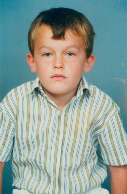 unsmiling little boy in striped shirt unsmiling little boy in striped shirt